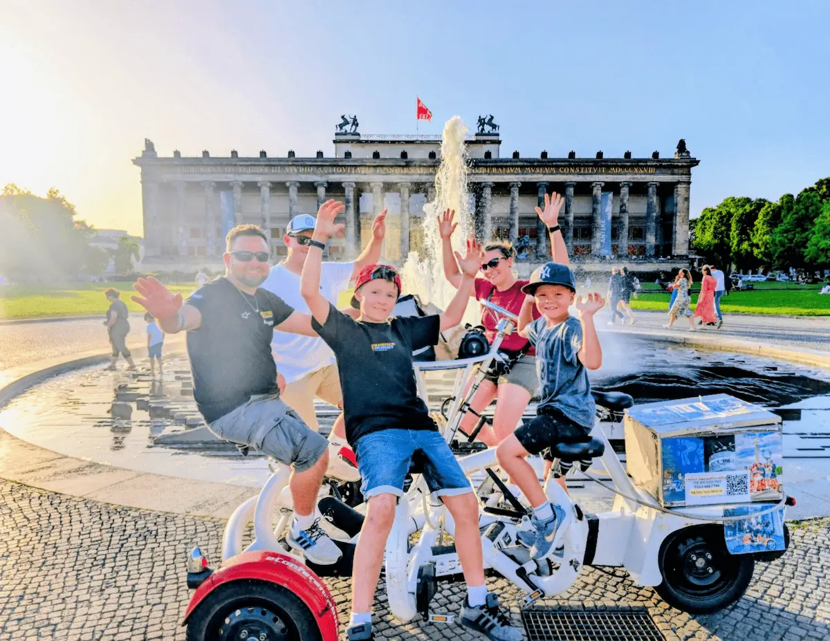 Glückliche Familie bei der Conferencebike Sightseeing Tour in Berlin inklusive gekühlten Getränken aus der Getränketasche.